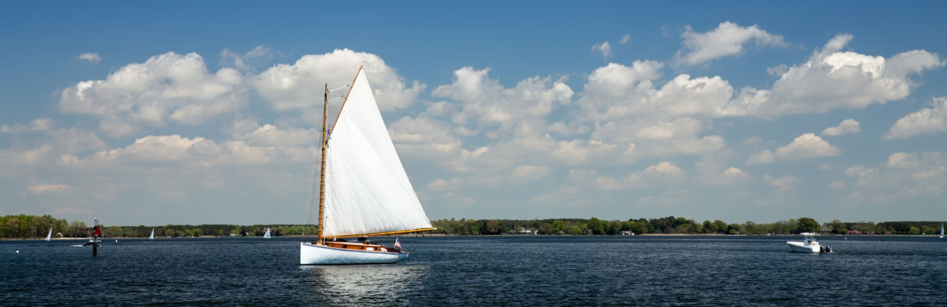 Sailboat on lake with blue skies